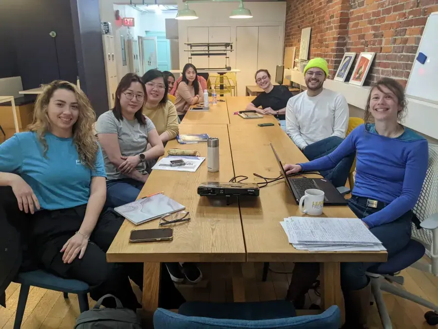 TEF TCF expression écrite, students studying French in Vancouver classroom with notebooks and projector