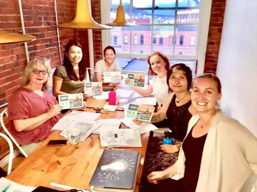 TEF TCF expression écrite, group of French students with learning materials in bright classroom