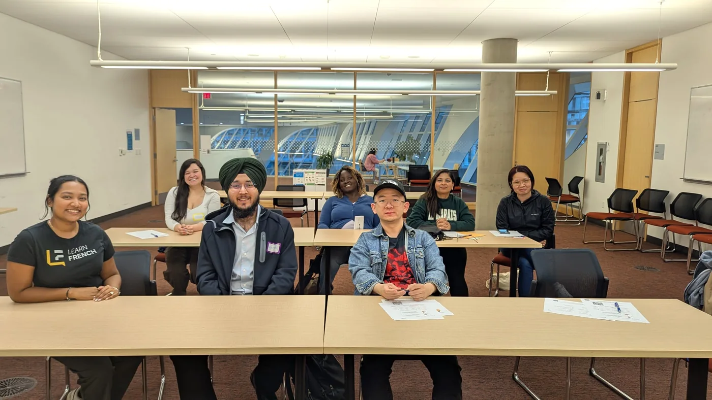 Students and their native French teacher seated in the Surrey City Centre Library classroom